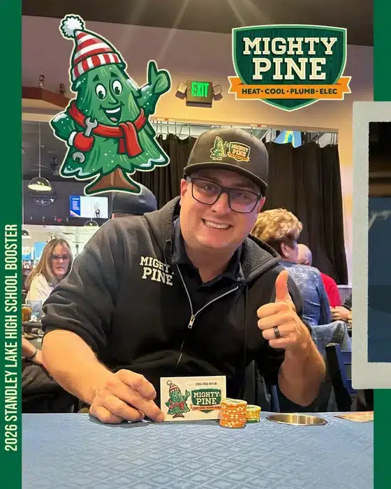 Mighty Pine team member in branded gear giving a thumbs-up at the 2026 Standley Lake High School Booster fundraiser