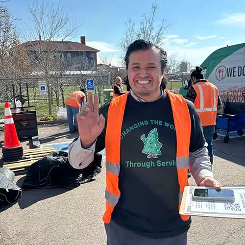 Mighty Pine employee smiling at community event in Arvada, CO.