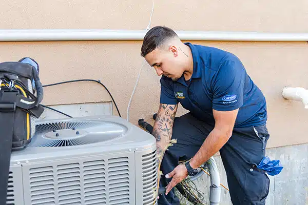Mighty Pine technician performing maintenance on an HVAC unit in Arvada, CO
