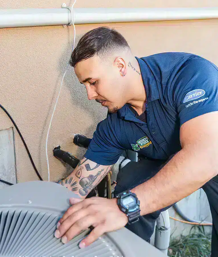 Mighty Pine technician performing maintenance on an HVAC unit in Arvada, CO