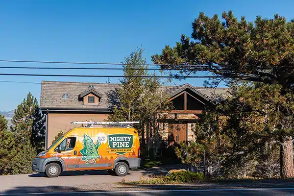 Mighty Pine truck parked in front of a residential home in Arvada, CO