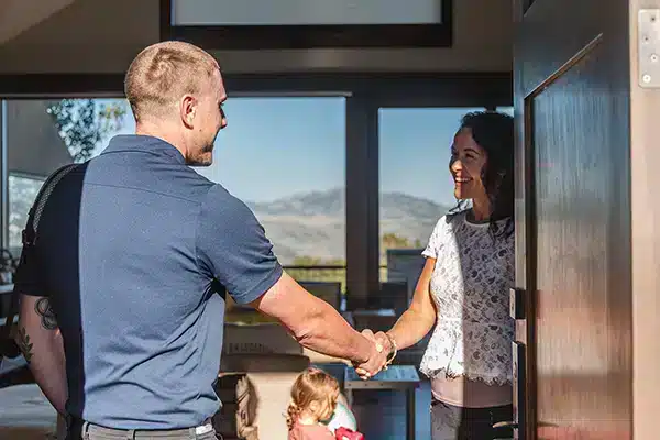 Mighty Pine technician shaking hands with a customer in Arvada, CO.