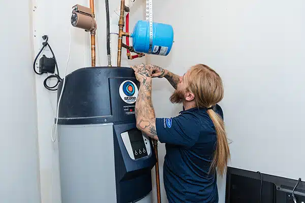 Mighty Pine technician installing a heat pump water heater in Arvada, CO