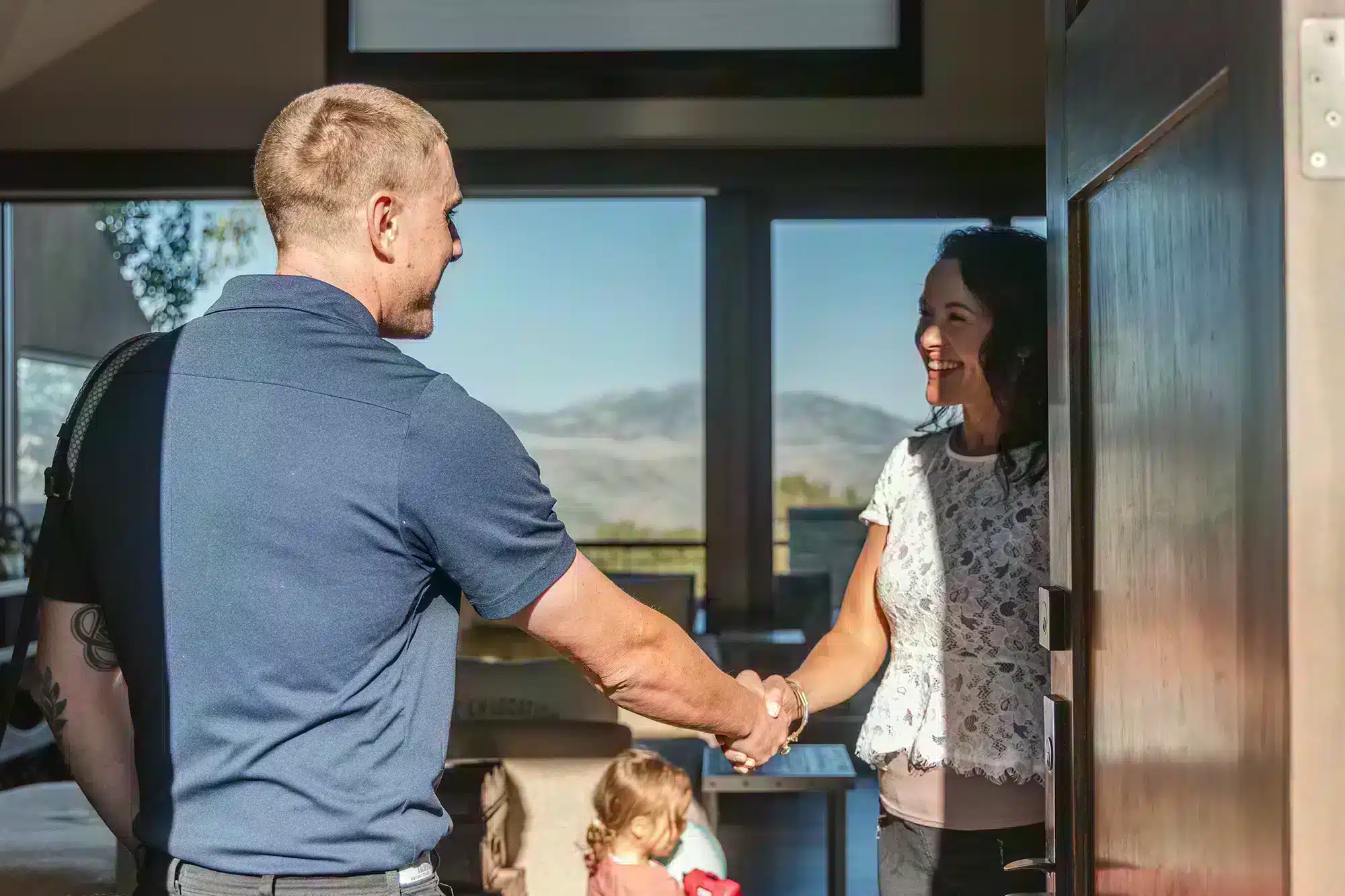 Mighty Pine technician shaking hands with a customer in Arvada, CO.