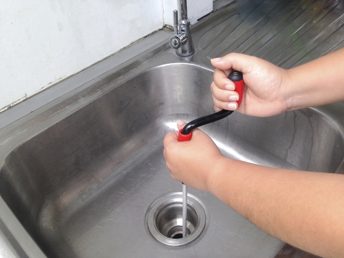 tech performing drain cleaning in arvada