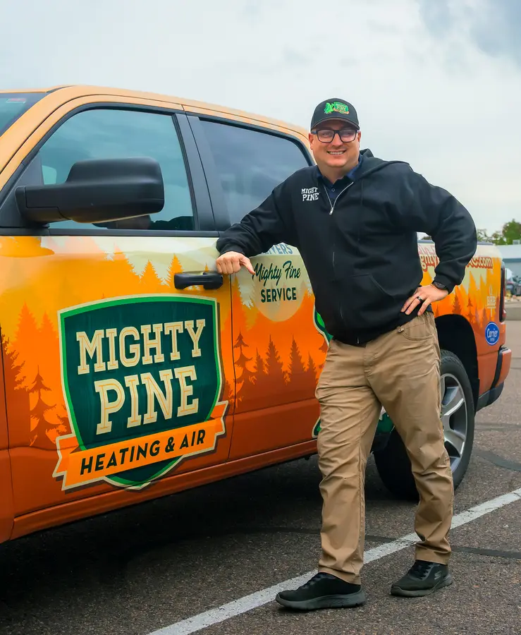Mighty Pine technician standing next to a Mighty Pine service truck in Arvada, CO