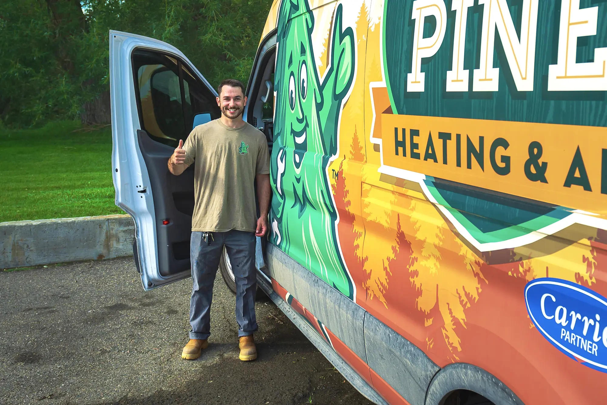 Mighty Pine technician giving a thumbs up beside a Mighty Pine service van in Arvada, CO