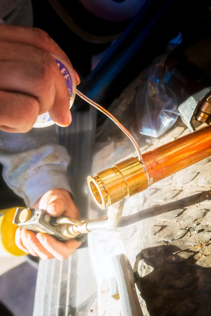 Mighty Pine technician soldering copper pipe