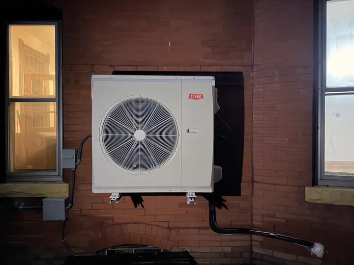 Wall-mounted heat pump outdoor unit installed by Mighty Pine