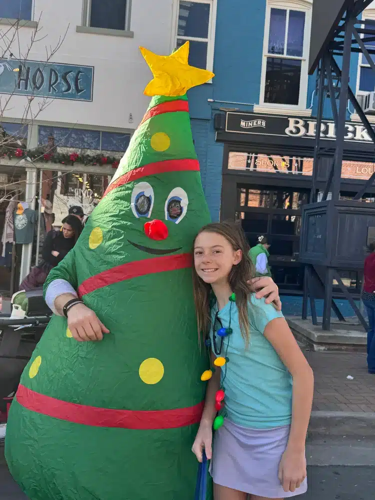 Mighty Pine the Christmas Tree with a happy kid.