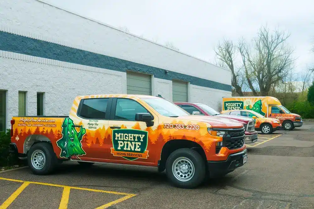 Mighty pine trucks outside of building in Arvada